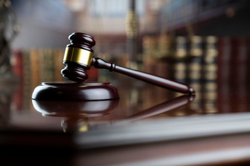Law and justice theme.  Gavel of  the judge on court library background.