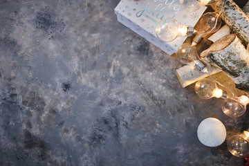 Christmas background with wood tree and decor. Top view with copy space and lighting bulb