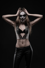 Fototapeta na wymiar Gothic model white-faced building grimace fancy makeup Halloween celebration