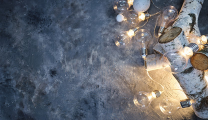 Christmas background with wood tree and decor. Top view with copy space and lighting bulb