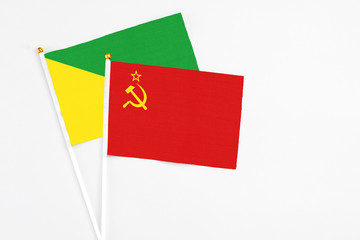 Soviet Union and French Guiana stick flags on white background. High quality fabric, miniature national flag. Peaceful global concept.White floor for copy space.