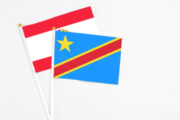 Congo and French Polynesia stick flags on white background. High quality fabric, miniature national flag. Peaceful global concept.White floor for copy space.