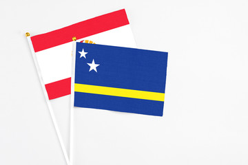 Curacao and French Polynesia stick flags on white background. High quality fabric, miniature national flag. Peaceful global concept.White floor for copy space.