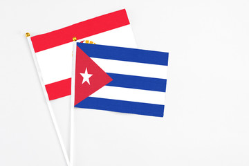 Cuba and French Polynesia stick flags on white background. High quality fabric, miniature national flag. Peaceful global concept.White floor for copy space.