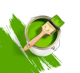 green paint tin can with brush on top on a white background with green strokes © Tjeerd