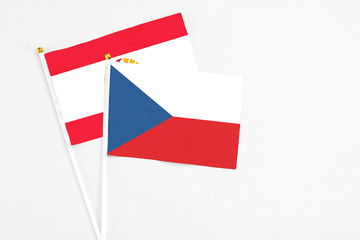 Czech Republic and French Polynesia stick flags on white background. High quality fabric, miniature national flag. Peaceful global concept.White floor for copy space.