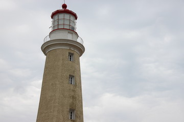 Fototapeta na wymiar lighthouse on background of blue sky