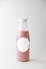 Service is available for vegans. Bottle of berry smoothie on white background.