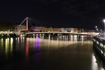 Fototapeta premium La passerelle du palais de justice sur la rivière Saône dans la ville de Lyon - Vue de nuit - Département du Rhône - France 