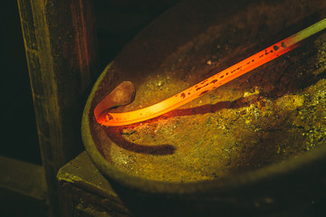 Incandescent element in the smithy on the iron anvil