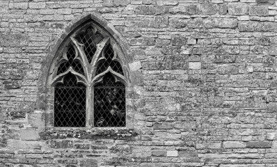 Old church window monochrome and stone wall