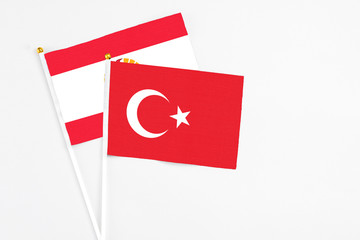 Turkey and French Polynesia stick flags on white background. High quality fabric, miniature national flag. Peaceful global concept.White floor for copy space.