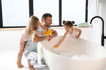 Young father with little daughters in bathroom