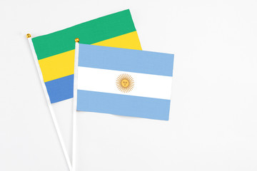 Argentina and Gabon stick flags on white background. High quality fabric, miniature national flag....