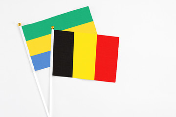 Belgium and Gabon stick flags on white background. High quality fabric, miniature national flag....