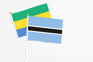 Botswana and Gabon stick flags on white background. High quality fabric, miniature national flag....
