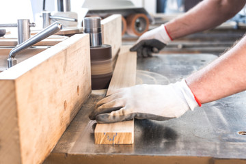 Fototapeta na wymiar polishing up wooden board on a carpentry machin 