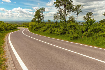 Fototapeta premium Straight asphalt road leading into the distance