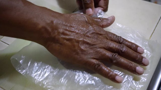 Black man making homemade traditional Arepa