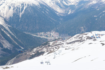cable car, ski resort, tourist village in the Caucasus mountains in spring, mountains and slopes