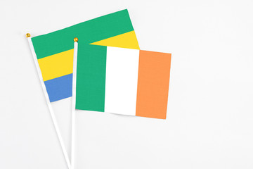 Ireland and Gabon stick flags on white background. High quality fabric, miniature national flag....