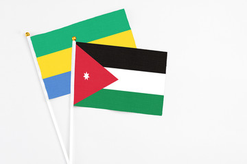 Jordan and Gabon stick flags on white background. High quality fabric, miniature national flag....