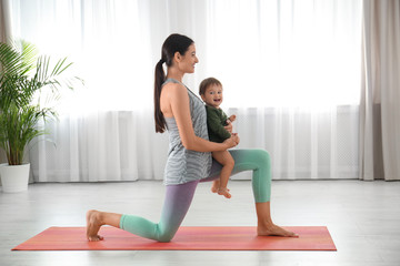 Obraz premium Young woman doing exercise with her son indoors. Home fitness
