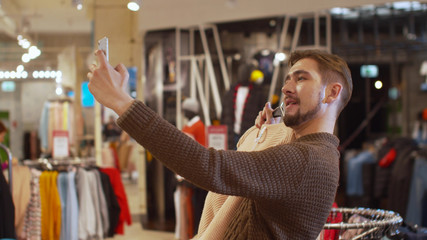 Happy guy takes a selfie with a jacket