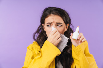 Sick woman isolated over purple wall background