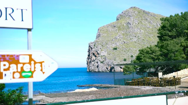 Breathtaking landscape of the high and steep slope of a mountain near the bright blue sea, summer vacation and travelling concept. Art. Cliff at the seashore.