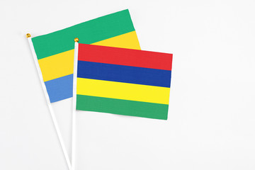 Mauritius and Gabon stick flags on white background. High quality fabric, miniature national flag....