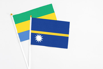 Nauru and Gabon stick flags on white background. High quality fabric, miniature national flag....