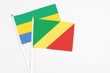 Republic Of The Congo and Gabon stick flags on white background. High quality fabric, miniature...
