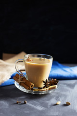 Flavoured masala Indian tea made by brewing black tea with milk, aromatic spices and herbs. Front view.