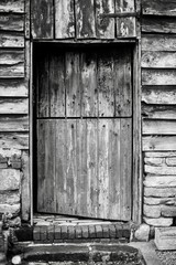 An old wooden door of a barn monochrome