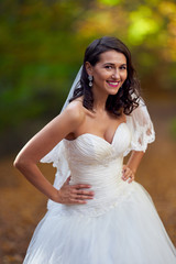 Fototapeta na wymiar Bride in white dress in the forest