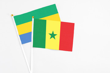 Senegal and Gabon stick flags on white background. High quality fabric, miniature national flag....