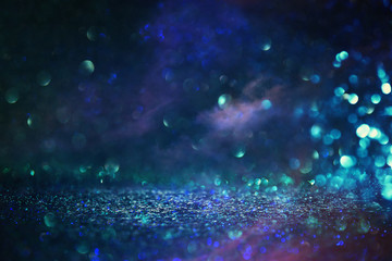 abstract glitter black and blue lights background. de-focused