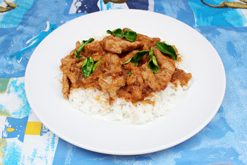 Rice with stir fried pork and kaffir lime leaves with panang curry on top,Thai food