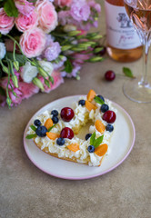 Heart shaped cake garnished with  berries