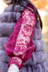 Young princess  in a beautiful red dress in park. The background is bright, golden autumn nature.
