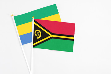 Vanuatu and Gabon stick flags on white background. High quality fabric, miniature national flag....