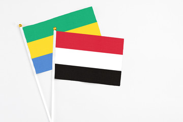 Yemen and Gabon stick flags on white background. High quality fabric, miniature national flag....