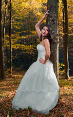 Bride in white dress in the forest