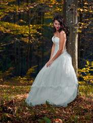 Fototapeta premium Bride in white dress in the forest