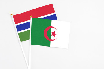 Algeria and Georgia stick flags on white background. High quality fabric, miniature national flag....