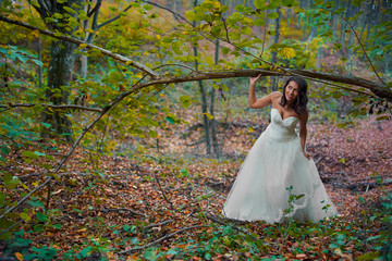 Fototapeta premium Bride in white dress in the forest