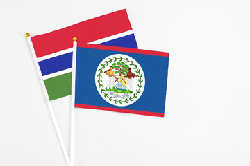 Belize and Georgia stick flags on white background. High quality fabric, miniature national flag. Peaceful global concept.White floor for copy space.