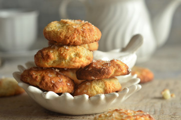 Round cookies on white cheese on a wooden background