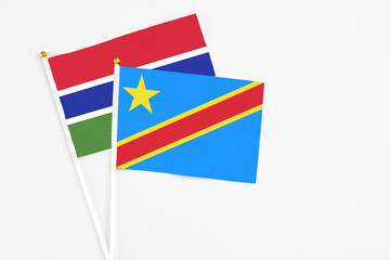 Congo and Georgia stick flags on white background. High quality fabric, miniature national flag. Peaceful global concept.White floor for copy space.